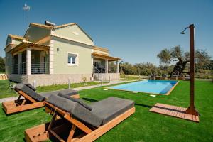 a house with a yard with a swimming pool at Luxury Villa Kokos-Private Pool in a Serene Natural Private Estate in Vitalades