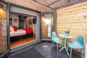 a room with a bed and a table and chairs at Duke Street Boutique Hotel in Liverpool