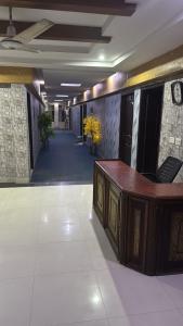 a hallway with a desk in a building at Hotel Lords Inn in Lahore