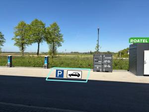 a parking lot with a parking sign on the street at Roatel Willich A44 my-roatel-com in Willich +2 photos