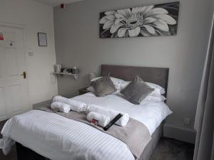 a bedroom with a bed with stuffed animals on it at The Swan Hotel in Kington