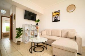 a living room with a couch and a table at Coastal nest in Perea