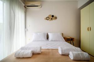 a bedroom with a large bed with two towels on it at Coastal nest in Perea