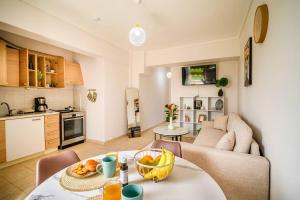 a living room with a table with a bowl of fruit on it at Coastal nest in Perea