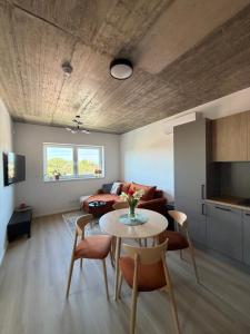a living room with a table and a couch at Apartmány u Zvonice in Kyjov