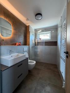 a bathroom with a sink and a toilet at Apartmány u Zvonice in Kyjov +38 photos