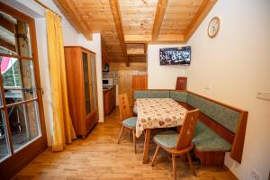 a kitchen and dining room with a table and chairs at Grossberghütte - Altfasstal in Mühlbach