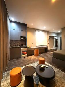 a living room with a couch and a kitchen at YourHome - Stay & More in Hoàng Mai