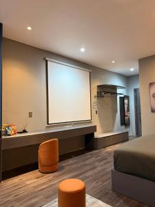 a bedroom with a large window with a bed and stool at YourHome - Stay & More in Hoàng Mai
