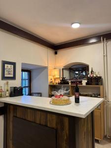 a kitchen with a table with a cake on a counter at Garni hotel Pana-Eustahije 253 in Kotor