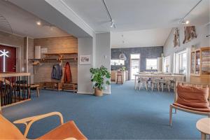 a room with tables and chairs and a dining room at Hemavan Mountain Lodge Storfjället in Hemavan