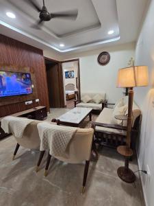 a living room with a couch and a tv at Ganges Abode in Haridwār