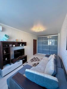 a large living room with a couch and a television at 7 Apartmens ЖК 7-Небо Аквапарк Промринок 7 in Odesa +3 photos