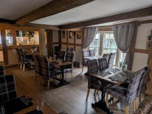 a dining room with tables and chairs and windows at The Swan Hotel in Kington