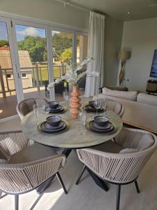 a dining room table with a vase on top of it at Mullins Townhouse in Saint Peter +27 photos