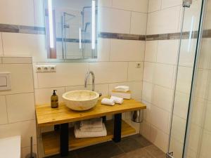 a bathroom with a sink and a shower at Zlattinger in Trebesing +26 photos