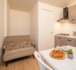 a living room with a table with a bowl of bread at Camping 4 Cerchi Ecogreen in Lido di Fermo