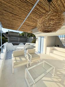 a patio with chairs and tables and a ceiling at Casa El Eden in Puerto Triunfo
