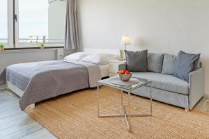 a bedroom with a bed and a couch and a table at Marina Wendtorf Kajüte in Wendtorf