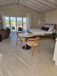 a bedroom with a bed and a table and chairs at Mullins Townhouse in Saint Peter