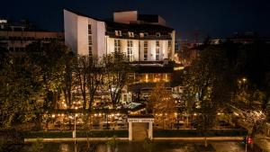 a building with lights in a city at night at Hotel Bosna Banja Luka in Banja Luka