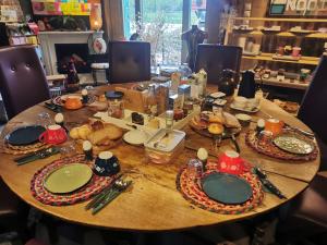a table with plates and utensils on it at B&B Klassiek in Twijzelerheide +16 photos