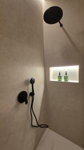 a shower in a bathroom with a light on the wall at LOS CUATRO CANTONES, Centro Ciudad in Palencia +42 photos