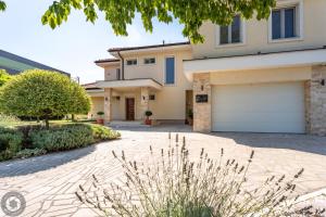 a house with a driveway and a garage at Vila Eleonora Beograd in Belgrade