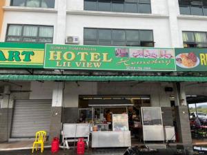 a building with a sign for a hotel in front of it at Hotel Lii View Labis in Labis