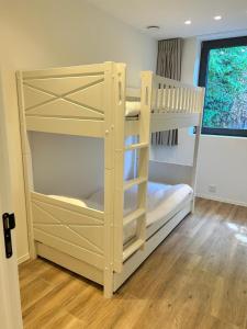 a bedroom with two bunk beds and a window at Tronc Verdi in Roeselare