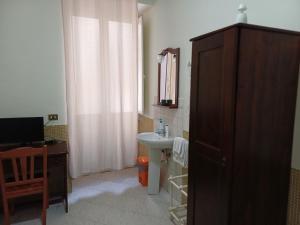 a bathroom with a sink and a mirror at Hotel Vittorio Veneto Napoli in Naples +38 photos