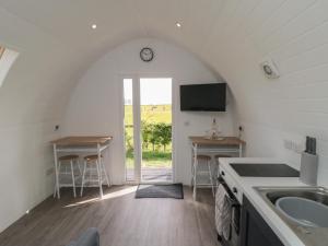 a kitchen with a sink and a clock on the wall at Starlight Sanctuary in Malton