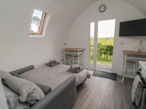 a bedroom with a bed and a desk and a window at Starlight Sanctuary in Malton