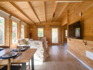 a living room with a table and chairs and a television at Rustic Home By CanariasGetaway in Telde