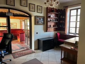 a living room with a red couch and a table at GASTHAUS SCHLUCKENAU in Šluknov