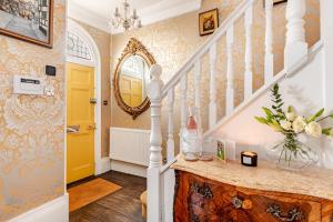 a home with a yellow door and a staircase at Warwick Centre Townhouse Castle views in Warwick +47 photos
