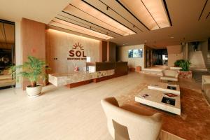 a lobby with a sofa and chairs in a building at Sol Boutique Hotel in Vlorë