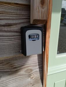 a digital thermometer on the side of a door at Charming Countryside Chalet in Mégrit