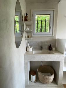 a bathroom with a sink and a mirror at L'évidence en Provence in Vachères +55 photos