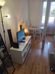 a living room with a desk with a computer on it at Spacieux studio prestige in Bischheim