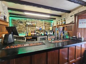a bar with a stone wall and a counter at River Black Water inn in Garve