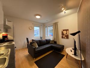a living room with a couch and a table at Kotimaailma - Saunallinen kolmio in Kokkola