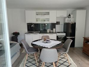 a small kitchen with a table and chairs in a room at Guest House Bee in Visoko
