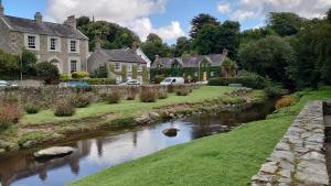 a river in a village with houses and a bridge at Lough View in Rostrevor