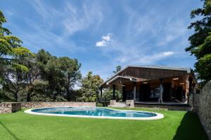 a house with a swimming pool in a yard at Sierra de Madrid Suites in Galapagar