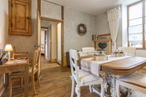 a dining room with a table and chairs at La Palette Fleurie in Laignes +23 photos