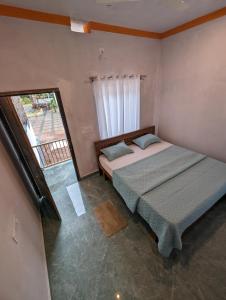 a bedroom with two beds and a window at Belandoor Nature Nest in Sringeri