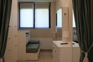 a hospital room with a mirror and a sink at Tevere 20 House in Monza