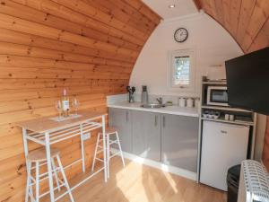 a kitchen with wooden walls and a table in a room at Cosy Cocoon in Malton