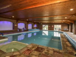 a large indoor swimming pool in a building at Cosy Cocoon in Malton